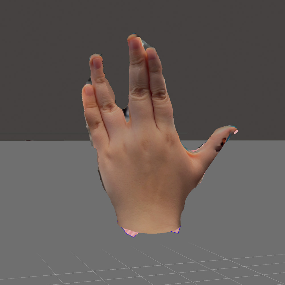 This is the 3d model of a hand making the vulcan salute in meshmixer after using scaniverse. I slightly edited the webbed fingers to make
          the silhouette more recognizable.